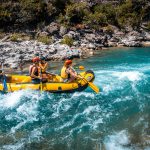 A group of people riding on the back of a raft